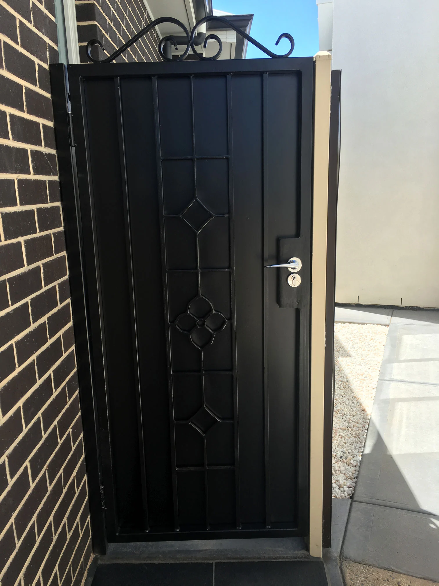 Black decorative steel security door with diamond detail