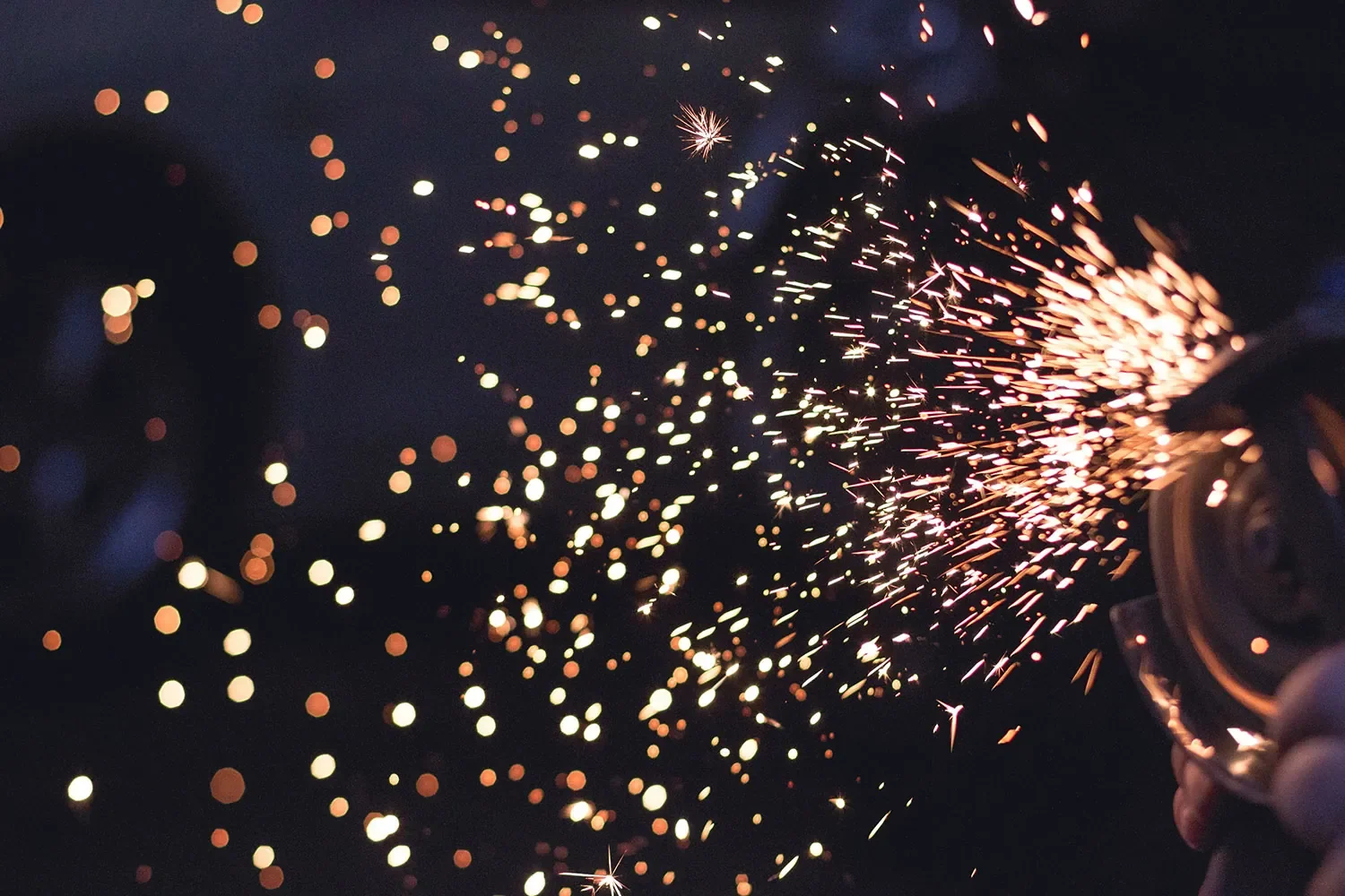 Sparks flying during metal fabrication in a workshop