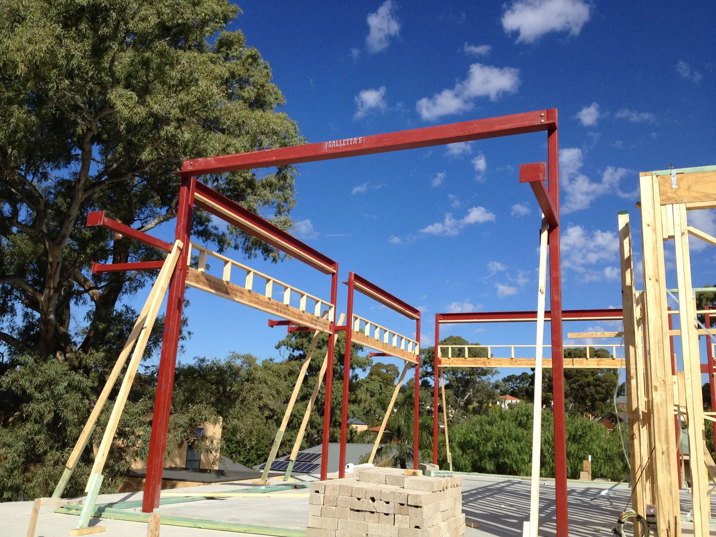 Red steel portal frame for a new residential build